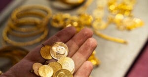 Human hand holding Turkish Gold coin in hand
